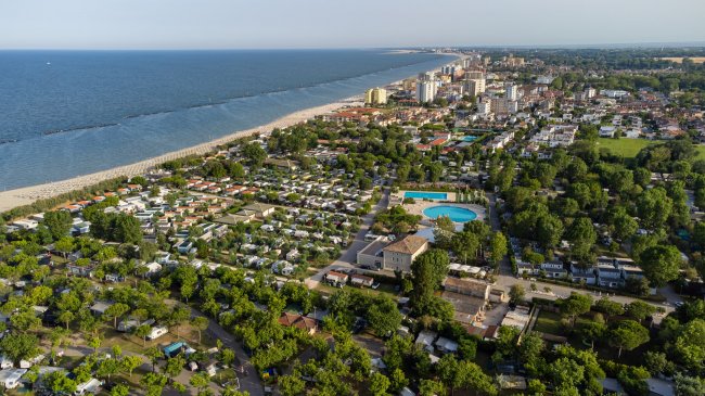 Vista aerea di un campeggio vicino alla spiaggia in una città costiera.