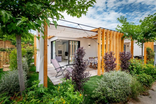 Veranda con sedie a sdraio e tavolo, giardino.