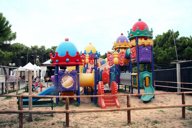 Colorato parco giochi recintato.